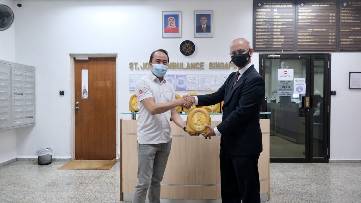 Mr Don Mok (left) handing over the HeartSine AED trainer set to St John Association, Dr. S.R.E Sayampanathan (right).